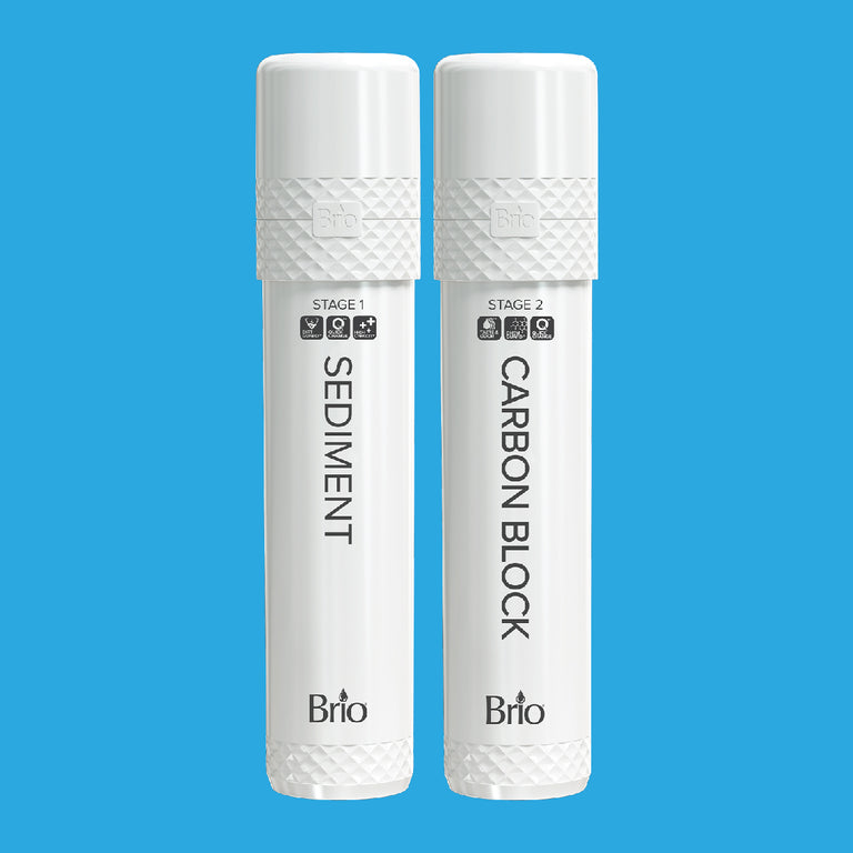 Two white cylindrical water filter cartridges labeled Stage 1 Sediment and Stage 2 Carbon Block by Brio, standing upright side by side on a blue background.
